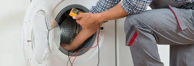 Dryer repair technician inspecting and repairing a clothes dryer in Yonkers, NY