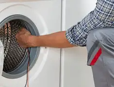 Dryer repair technician diagnosing and servicing a clothes dryer in Yonkers, NY