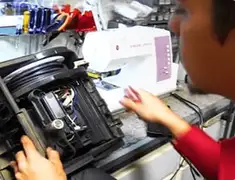 Vacuum repair technician servicing internal components on a workbench in Yonkers, NY
