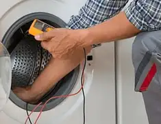 Washing machine repair technician testing a front-load washer with diagnostic tools in Yonkers, NY